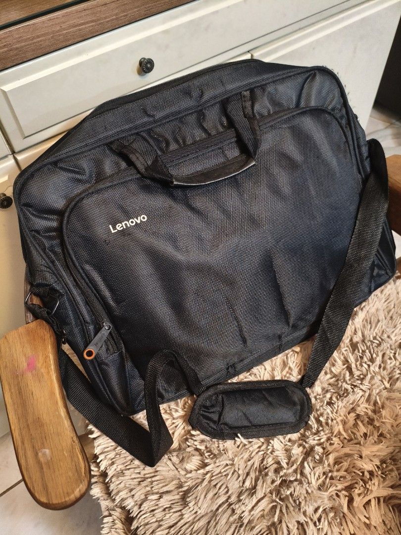 Lenovo Laptop Bag (Category: Laptop Bags & Sleeves) located in Imus. Submitted by umusthave23 (Listing ID 1403809340, Image 1). Description: Black Lenovo laptop bag with a shoulder strap and a handle. It has multiple compartments, including a main compartment and a front pocket. It has a padded shoulder strap for comfortable carrying. The bag is designed to protect a laptop during transport. selling low at 200 because of: issue: 1 strap needs to 