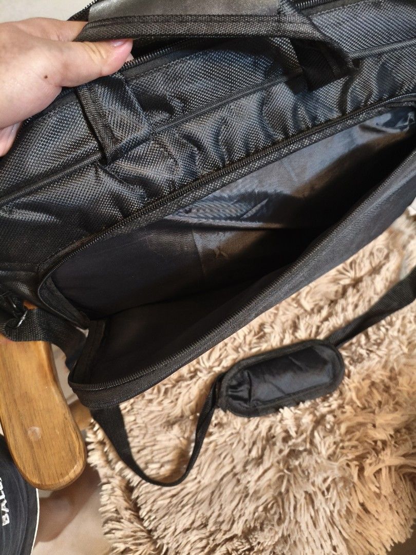 Lenovo Laptop Bag (Category: Laptop Bags & Sleeves) located in Imus. Submitted by umusthave23 (Listing ID 1403809340, Image 3). Description: Black Lenovo laptop bag with a shoulder strap and a handle. It has multiple compartments, including a main compartment and a front pocket. It has a padded shoulder strap for comfortable carrying. The bag is designed to protect a laptop during transport. selling low at 200 because of: issue: 1 strap needs to 