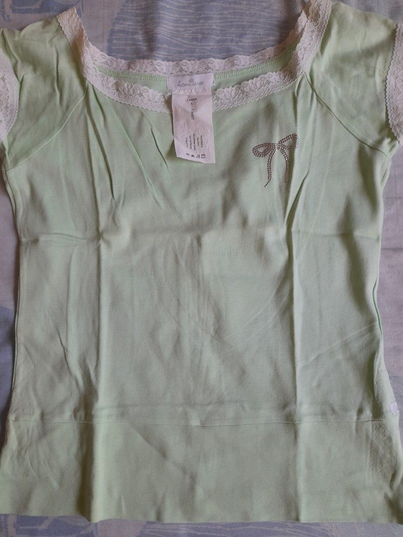 Mint Green Blouse with Lace Trim (Category: Blouses) located in San Pedro. Submitted by JohnsonKeeps (Listing ID 1403836675, Image 1). Description: - Mint Green Blouse - Lace trim on neckline and sleeves - Small bow detail - Size L (slim fit) - flaws, minor discoloration in lace trim due to stock (see picture).