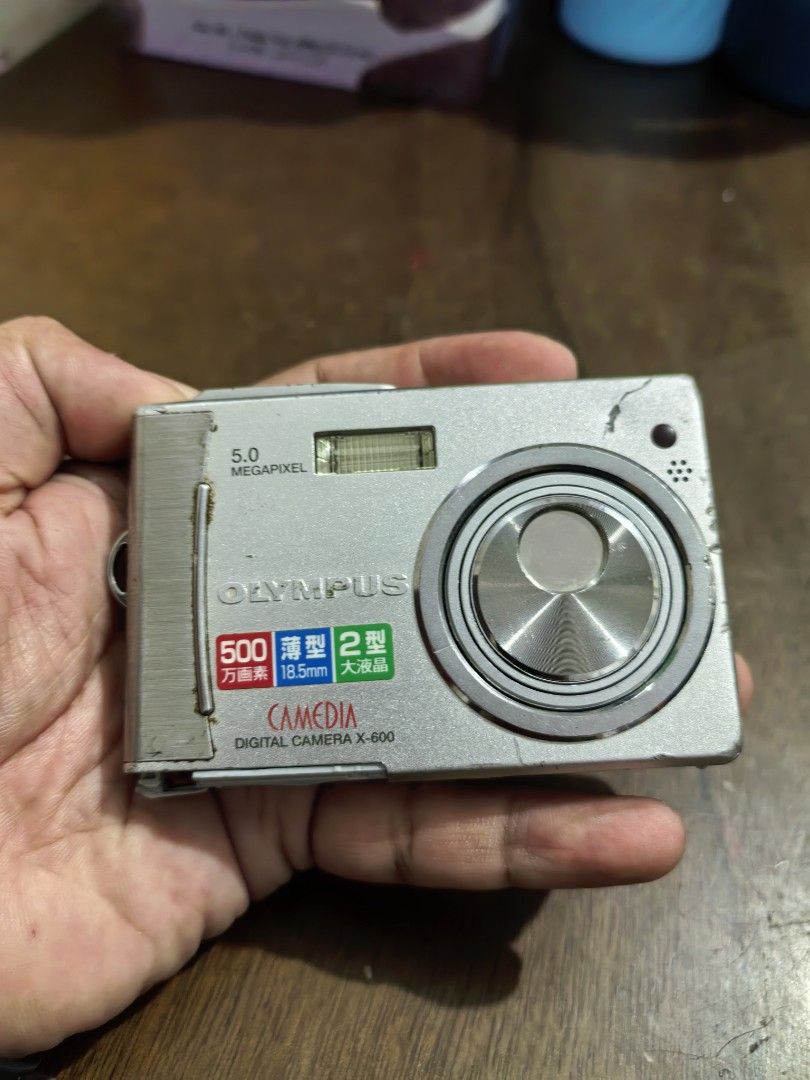 Olympus CAMEDIA X-600 Digital Camera (Category: Cameras) located in Cebu City. Submitted by dudes_villanueva (Listing ID 1403825568, Image 1). Description: Olympus CAMEDIA X-600 Digital Camera. Note: Untested. Possible Non-Functional See All photos for condition. Sold as is. All sales final and non-refundable. For Restoration, collection, or parts. Condition: Damaged Battery Cover. No Battery. Untested. 📌It has a 5.0-megapixel sensor and a 3x op