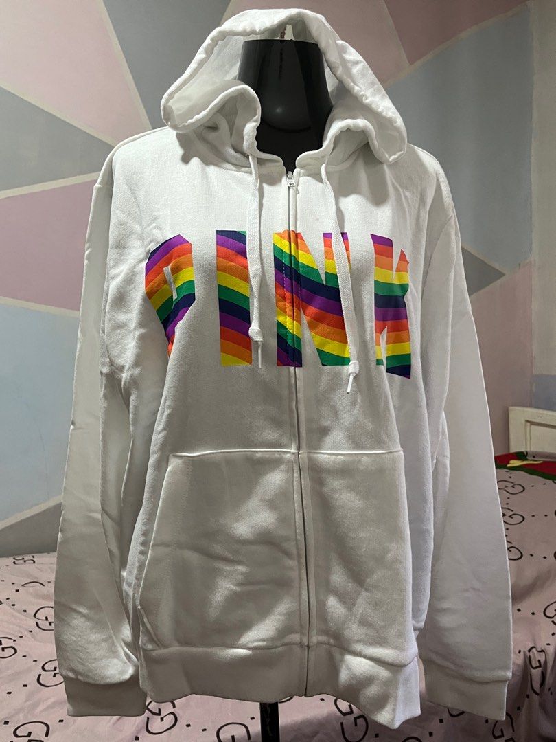 Pink by VS XXL Hoodie (Category: Coats, Jackets and Outerwear) located in Antipolo. Submitted by lisyel (Listing ID 1403846677, Image 2). Description: - Pink by Victoria's Secret hoodie - White color - Full zip closure - Features a hood - Rainbow "PINK" print on the front - Two front pockets - Size: XXL.