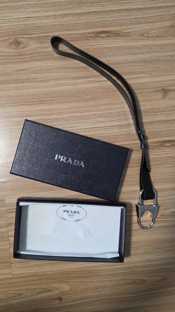 Prada strap with Box authentic (Category: Luxury Bags & Wallets) located in Makati City. Submitted by auno520hda (Listing ID 1403812228, Image 1). Description: Authentic Prada strap. Includes the original box . The strap is made of leather and has a metal clasp. The box is black with the Prada logo in white. The interior of the box has a white paper with the Prada logo. meet up in Makati please text me in English.