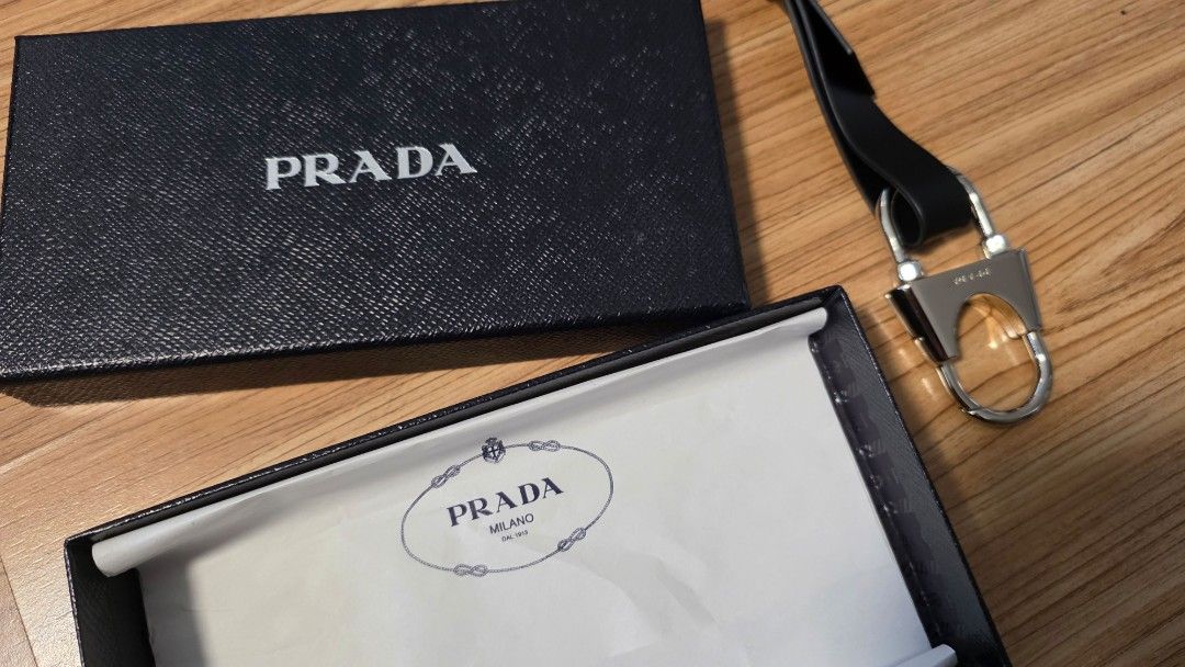 Prada strap with Box authentic (Category: Luxury Bags & Wallets) located in Makati City. Submitted by auno520hda (Listing ID 1403812228, Image 2). Description: Authentic Prada strap. Includes the original box . The strap is made of leather and has a metal clasp. The box is black with the Prada logo in white. The interior of the box has a white paper with the Prada logo. meet up in Makati please text me in English.
