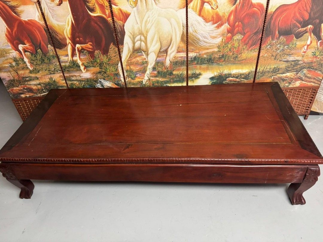 Solid wood coffee table (Category: Tables & Sets) located in Singapore. Submitted by pmspl (Listing ID 1403847039, Image 1). Description: Dimensions: 180cm (L) x 76cm (W) x 41cm (H) Material: Solid wood Color: Deep reddish-brown finish Style: Classic/ Traditional 1. Strong and durable construction 2. Intricately carved legs and edging 3. Spacious, ideal for living rooms or as a low display table 4. Great statement piece in both modern or traditio