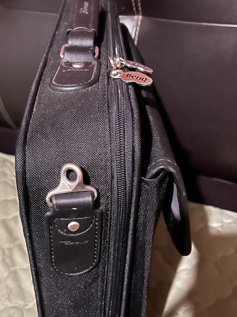 Targus BenQ Laptop Bag (Category: Laptop Bags & Sleeves) located in Angeles City. Submitted by goodbuysathome (Listing ID 1403966099, Image 3). Description: Black Targus laptop bag with BenQ branding. Features a handle and a detachable shoulder strap. Includes multiple compartments and pockets inside for organization. The bag has a zipper closure and a Targus logo on the side. It also has a tag that says "Inspected with Pride by Targus". Looks br