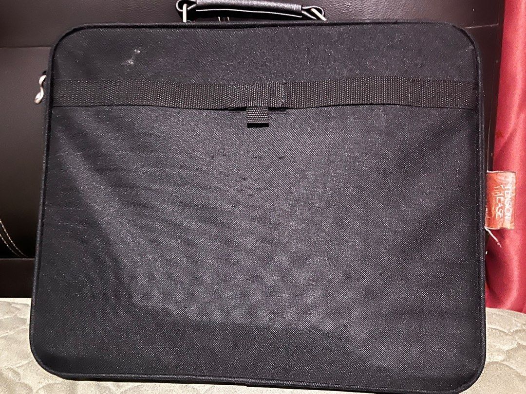 Targus BenQ Laptop Bag (Category: Laptop Bags & Sleeves) located in Angeles City. Submitted by goodbuysathome (Listing ID 1403966099, Image 2). Description: Black Targus laptop bag with BenQ branding. Features a handle and a detachable shoulder strap. Includes multiple compartments and pockets inside for organization. The bag has a zipper closure and a Targus logo on the side. It also has a tag that says "Inspected with Pride by Targus". Looks br