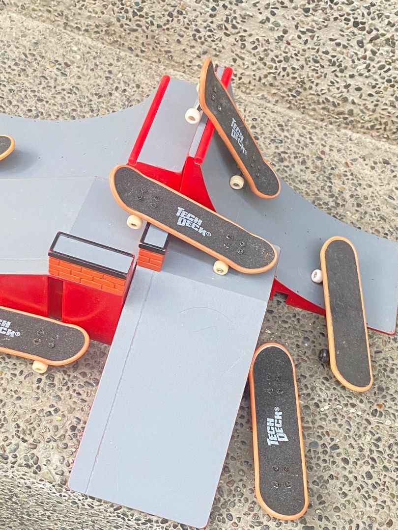 Tech Deck Fingerboard Ramp Set (Category: Action & Battle Toys) located in Manila. Submitted by 3asonlineshop (Listing ID 1403858199, Image 2). Description: - Tech Deck fingerboard set - Features a gray and red ramp with multiple levels and obstacles - Includes several fingerboards with the Tech Deck logo - Also includes small gray pieces - Great for fingerboard enthusiasts!.