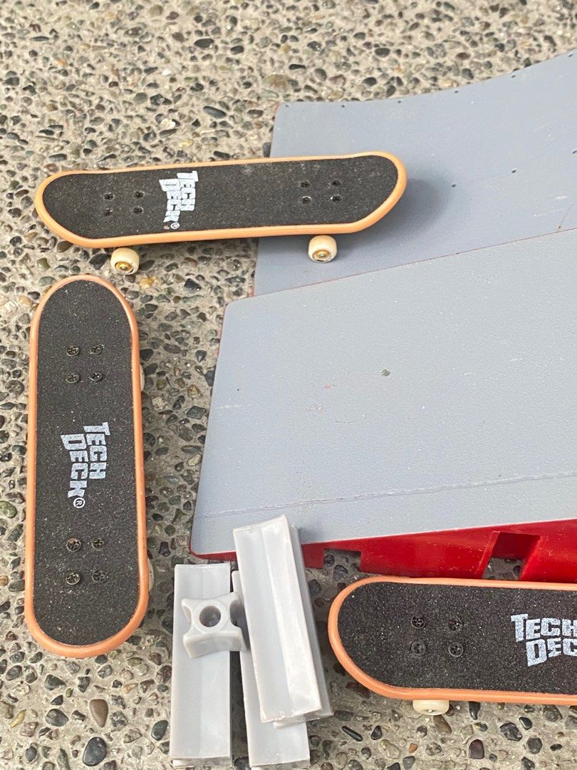 Tech Deck Fingerboard Ramp Set (Category: Action & Battle Toys) located in Manila. Submitted by 3asonlineshop (Listing ID 1403858199, Image 3). Description: - Tech Deck fingerboard set - Features a gray and red ramp with multiple levels and obstacles - Includes several fingerboards with the Tech Deck logo - Also includes small gray pieces - Great for fingerboard enthusiasts!.