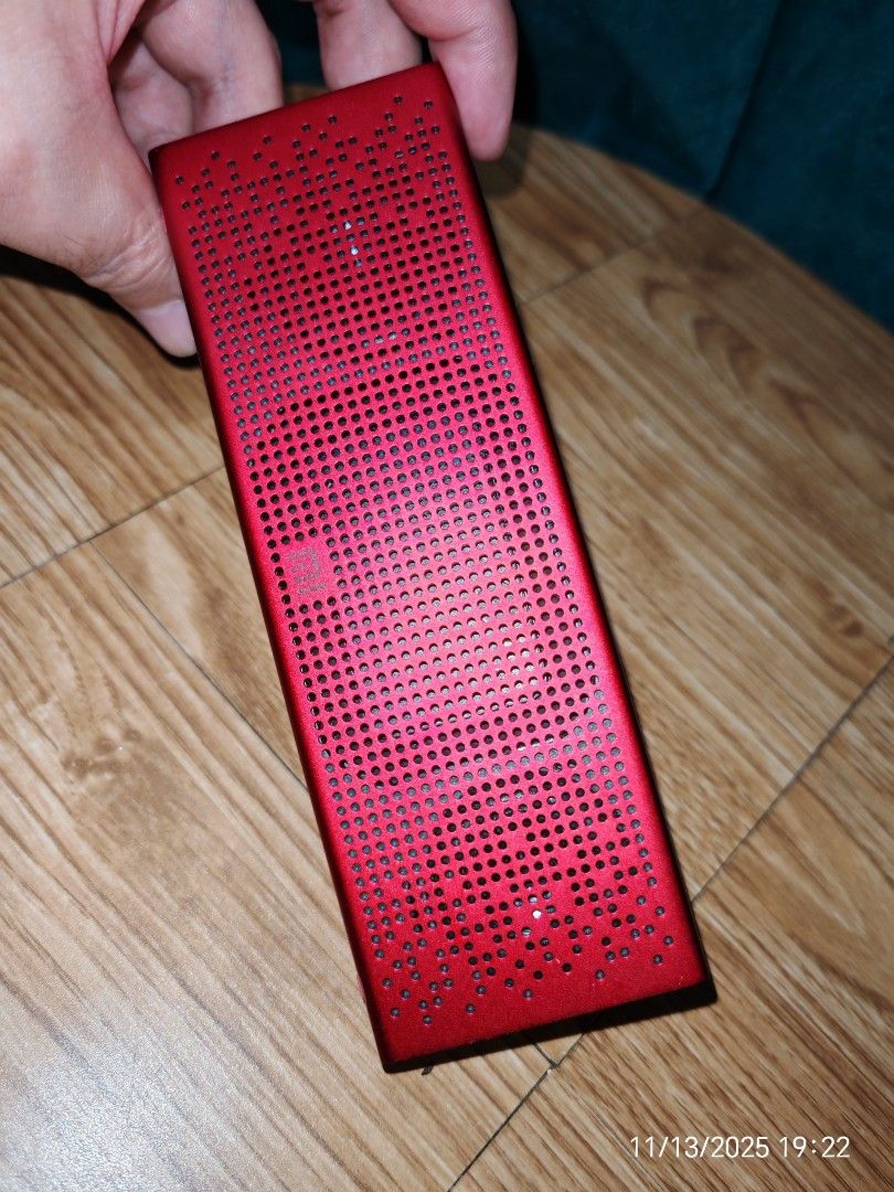 Xiaomi Mi Bluetooth Speaker (Category: Soundbars, Speakers & Amplifiers) located in Baguio. Submitted by baguiobeans (Listing ID 1403923441, Image 1). Description: - Red Xiaomi Mi Bluetooth speaker - Playback controls on top panel - Perforated metal grill - Xiaomi logo and model information on the back - Compact, rectangular design.