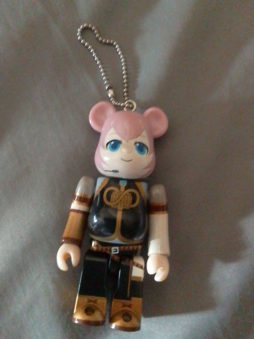 Bearbrick Megurine Luka Keychain (Category: Designer & Blind Box Toys) located in Santa Rosa. Submitted by animemerchcollection (Listing ID 1404052453, Image 1). Description: - Bearbrick keychain - Features a character with pink ears and blue eyes - Black and gold outfit - Attached to a silver chain - Collectible item.