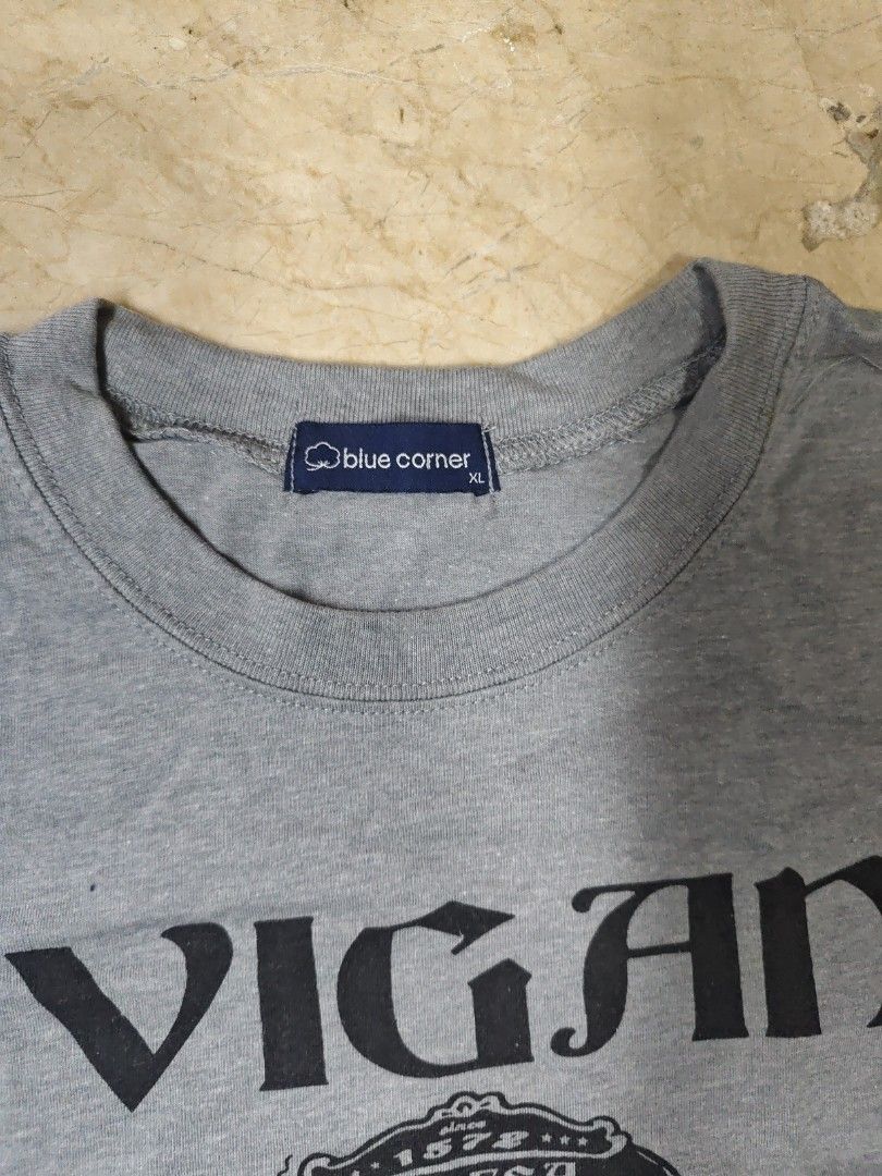 Blue Corner Vigan Philippines Graphic Tee - XL (Category: Tshirts & Polo Shirts ) located in Makati City. Submitted by tekhowz (Listing ID 1404037833, Image 2). Description: Gray t-shirt featuring a graphic print of Vigan, Philippines. The print includes an image of a horse-drawn carriage and the text "Vigan" and "Ilocos Sur Philippines". The fabric looks soft and comfortable. width - 21.5 length - 29.