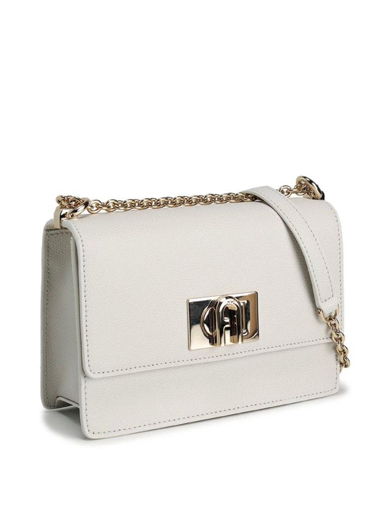 Furla 1927 Mini Crossbody Bag (Category: Luxury Bags & Wallets) located in Angat. Submitted by shopmyclosetbykris (Listing ID 1404111131, Image 1). Description: FURLA 1927 Mini Pebbled Leather in GHW Color: Marshmallow (White) Twist lock closure Can be worn as shoulder or crossbody bag Dimensions: L20cm x H13.5cm x W7cm Can fit iphone promax Complete with tag, booklet, dust bag & paper bag Price on tag: $428 (25,000 plus in php) SELLING for only 