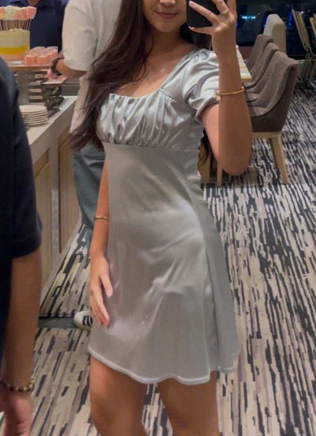 H&M Satin Mini Dress with Puff Sleeves (Category: Dresses) located in Cebu City. Submitted by preloved_ishaa (Listing ID 1404148157, Image 2). Description: Elegant mini dress in soft, silvery-grey satin. Features a square neckline, puff sleeves, and a flattering silhouette. Perfect for special occasions..