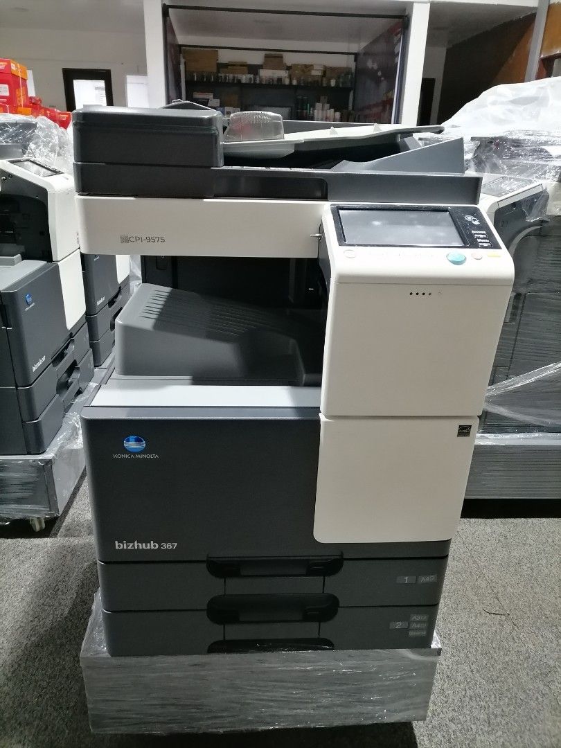 Konica Minolta Bizhub 367 Multifunction Printer (Category: Cameras) located in Quezon City. Submitted by copieronlineinc (Listing ID 1404050055, Image 1). Description: Konica Minolta Bizhub 367 multifunction printer. Features a touchscreen control panel and multiple paper trays. The scanner lid can be opened. The printer has a black and white color scheme..