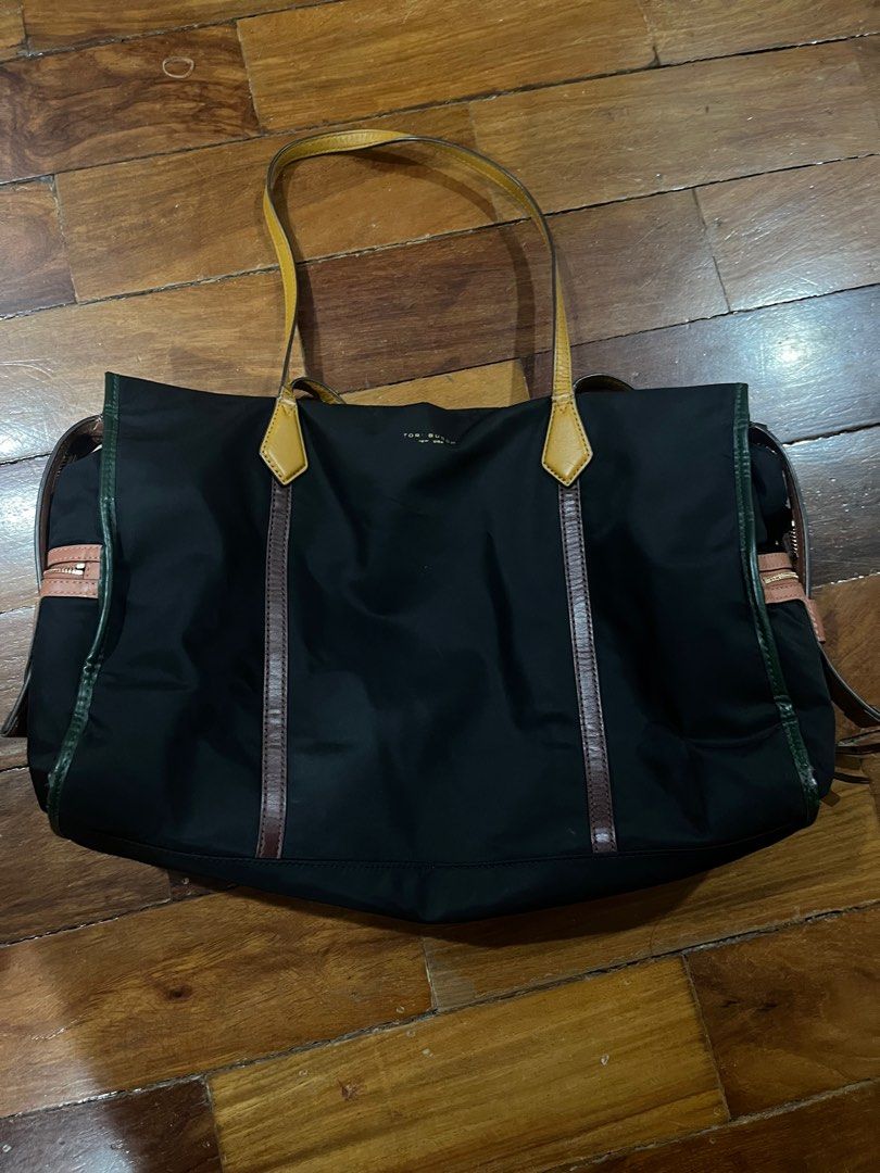 Nylon Tory Burch Bag (Category: Luxury Bags & Wallets) located in Paranaque City. Submitted by nikkis100 (Listing ID 1404163145, Image 2). Description: Hi! This is an original Tory Burch bag purchased from the US. The bag design is unique but wearable, though there are evident signs of wear and tear in the straps specifically. .