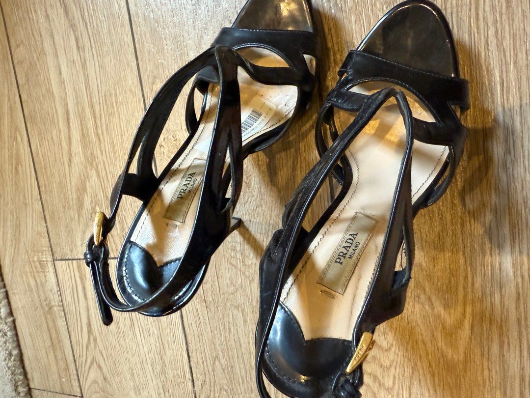 Prada Black Patent Leather Sandals (Category: Flats & Sandals) located in Taguig. Submitted by editroomph (Listing ID 1404000369, Image 2). Description: Elegant Prada sandals in black patent leather. Features a strappy design with a gold buckle closure. Size 36. Made in Italy. Gold-tone hardware. 100% authentic Shipping: c/o buyer Pick up Metro Manila.