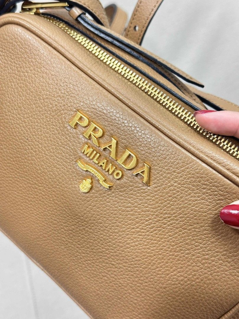 Prada Camera bag in leather (Category: Luxury Bags & Wallets) located in Passi. Submitted by janbelisario (Listing ID 1404047838, Image 3). Description: lighly used conditions Guaranteed original with dustbag and cards in brown leather yy.