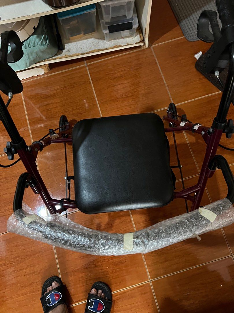 Rolling Walker with Seat without footrest (Category: Rehabilitative Devices) located in Las Pinas. Submitted by jerri44 (Listing ID 1404023514, Image 2). Description: - Rolling walker with seat and handles - Easy maneuverability with wheels - Dark red frame - Practical mobility aid.