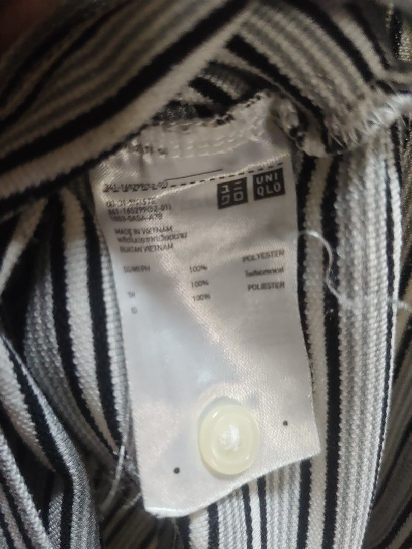 Uniqlo Striped Polo Shirt - Medium (Category: Tshirts & Polo Shirts ) located in Makati City. Submitted by tekhowz (Listing ID 1404005784, Image 3). Description: Uniqlo polo shirt features a classic striped design with a white collar. It is made of polyester. The shirt has a button-down closure. Made in Vietnam. some torn inside the collar width - 21 inches length - 26 inches.