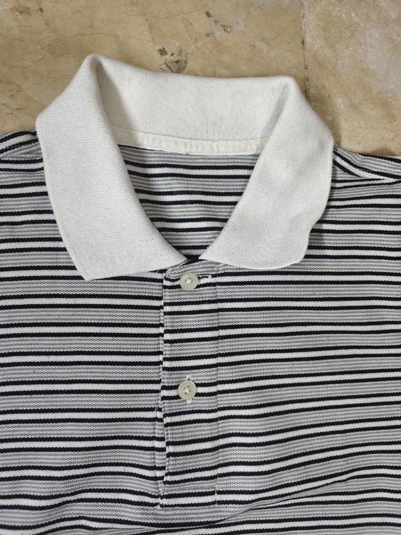 Uniqlo Striped Polo Shirt - Medium (Category: Tshirts & Polo Shirts ) located in Makati City. Submitted by tekhowz (Listing ID 1404005784, Image 2). Description: Uniqlo polo shirt features a classic striped design with a white collar. It is made of polyester. The shirt has a button-down closure. Made in Vietnam. some torn inside the collar width - 21 inches length - 26 inches.