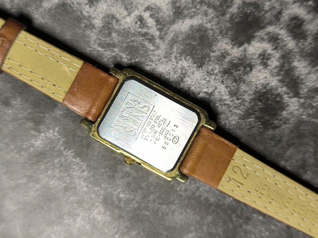 Virginia Slims Watch (Category: Women's Watches) located in Pasay City. Submitted by cassiuss (Listing ID 1404010928, Image 2). Description: Vintage Virginia Slims watch with a rectangular gold-toned case and a white dial. Features a unique flip-style display for the hour. The watch has a brown leather strap. The back of the watch is marked with "Virginia Slims" and "Stainless Steel". Japan movement, Very stylish..