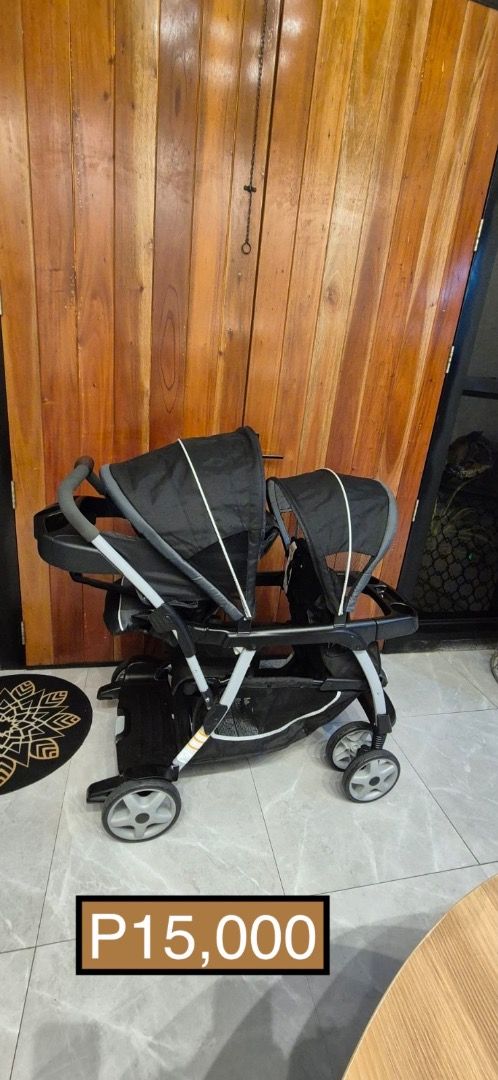 Double Stroller Graco (Category: Strollers) located in Quezon City. Submitted by shopus2mnl (Listing ID 1404278910, Image 1). Description: Double stroller is perfect for families with twins or two young children. It features two seats with canopies for sun protection. The stroller has a black frame and wheels. The price is P15,000..