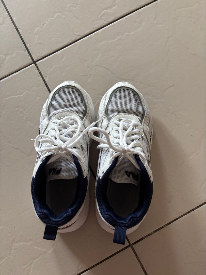 Fila Sneakers White Navy Size 7W (Category: Sneakers) located in Dasmarinas. Submitted by preloved.frommary (Listing ID 1404211906, Image 2). Description: - White and navy Fila sneakers - Mesh upper - White laces - Navy blue collar and pull tab.