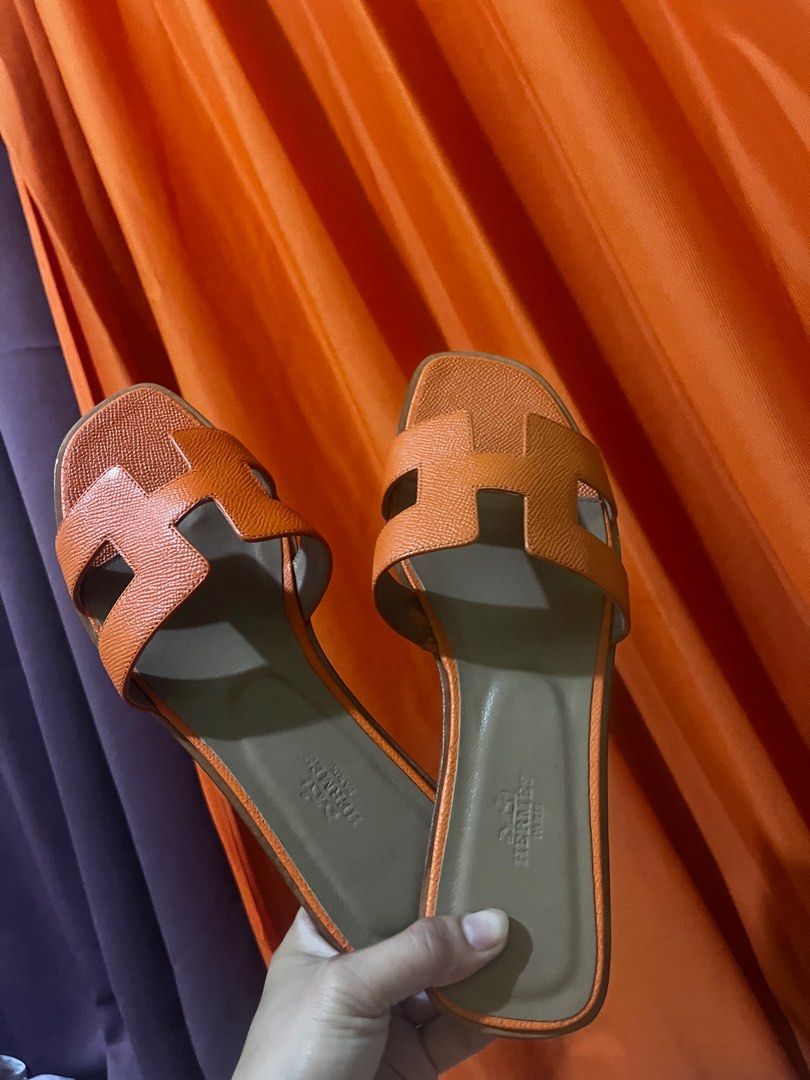 Hermès Oran Sandals Orange Size 40 (Category: Flats & Sandals) located in Paranaque City. Submitted by maineshar19 (Listing ID 1404355408, Image 1). Description: - Authentic Hermès Oran sandals - Color: Orange - Size: 40 - Iconic H cut-out design - Made in Italy - Condition: Good - Minor wear on soles.