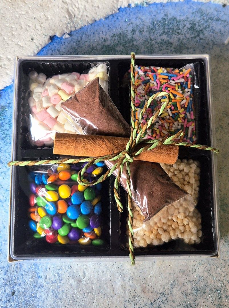 Hot Chocolate Gift Set (Category: Gift Baskets & Hampers) located in Quezon City. Submitted by shopus2mnl (Listing ID 1404244107, Image 2). Description: - Hot Chocolate Gift Set - Includes: - Hot chocolate mix - Marshmallows - Colorful sprinkles - Crispy rice treats - Cinnamon stick - Beautifully presented in a gift box - Perfect for gifting!.