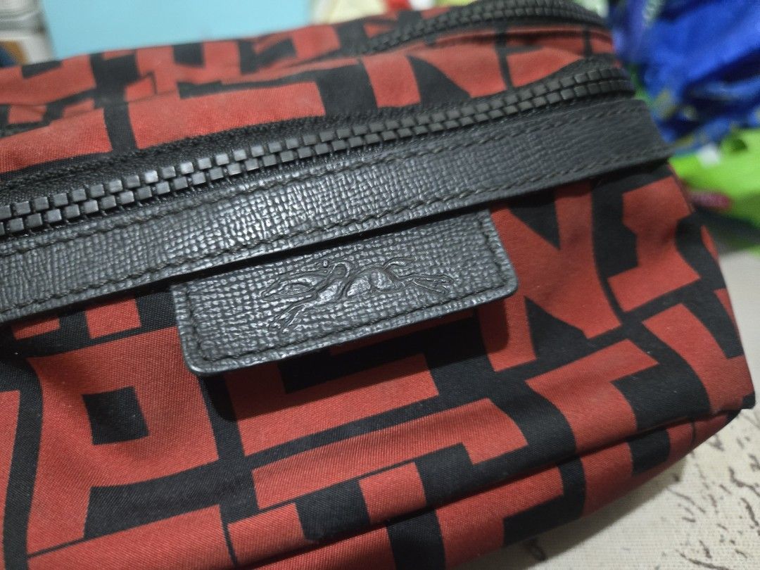 Longchamp Waist Bag Red and Black (Category: Luxury Bags & Wallets) located in Manila. Submitted by artefinds_ph (Listing ID 1404352880, Image 3). Description: - Longchamp waist bag - Color: Red and Black - Main compartment - Multiple card slots - Zippered pocket - Adjustable black strap - Buckle closure - Longchamp logo on front - Red interior lining.