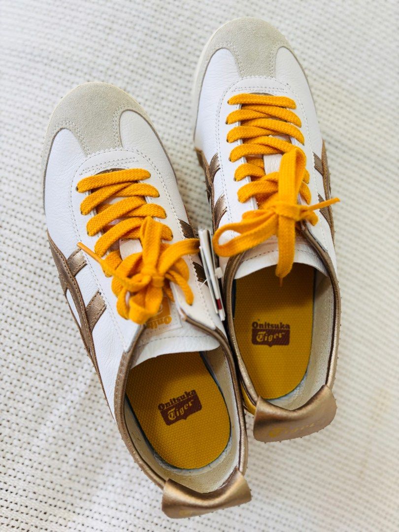 Onitsuka Tiger Mexico 66 - White/Gold (Category: Sneakers) located in Los Banos. Submitted by mommy_rizza (Listing ID 1404258843, Image 2). Description: Onitsuka Tiger Mexico 66 sneakers in white and gold. Features the iconic tiger stripes and a classic design. Includes original tags. Size 26.5. The shoes have yellow laces and a yellow insole. A stylish and comfortable choice for everyday wear. No box. .