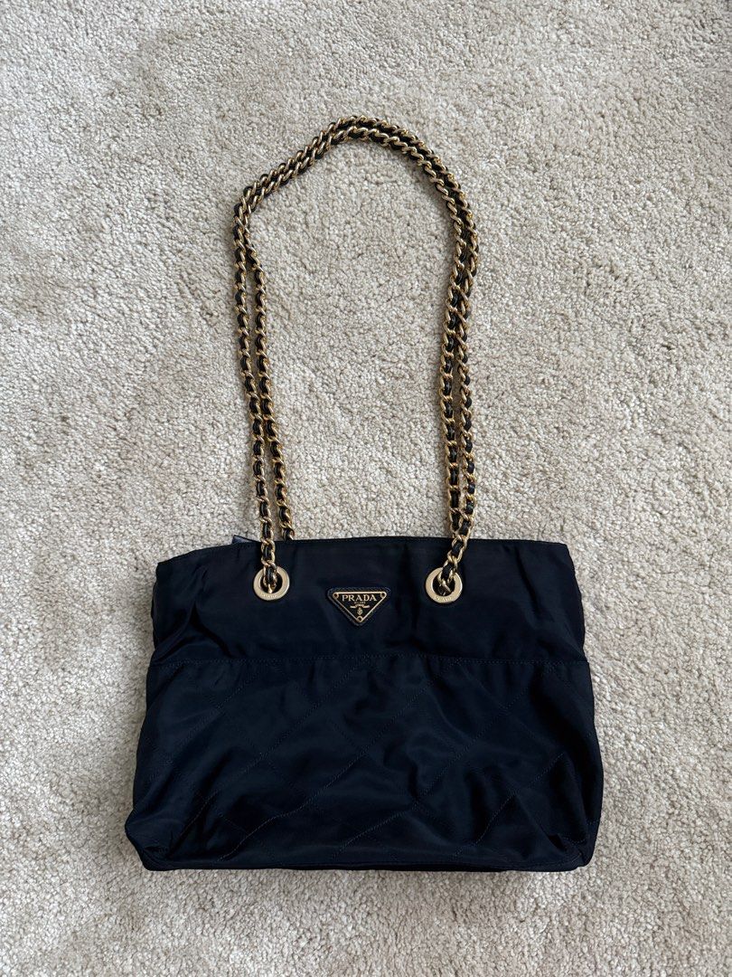 Prada Nylon Chain Bag (Category: Luxury Bags & Wallets) located in Manila. Submitted by jazzzzz06 (Listing ID 1404211776, Image 1). Description: - Authentic Prada Shoulder bag -with authenticity card - Navy Blue (near black) nylon material - Elegant gold-tone chain straps -dust bag included - Stylish quilted design - Secure zipper closure .