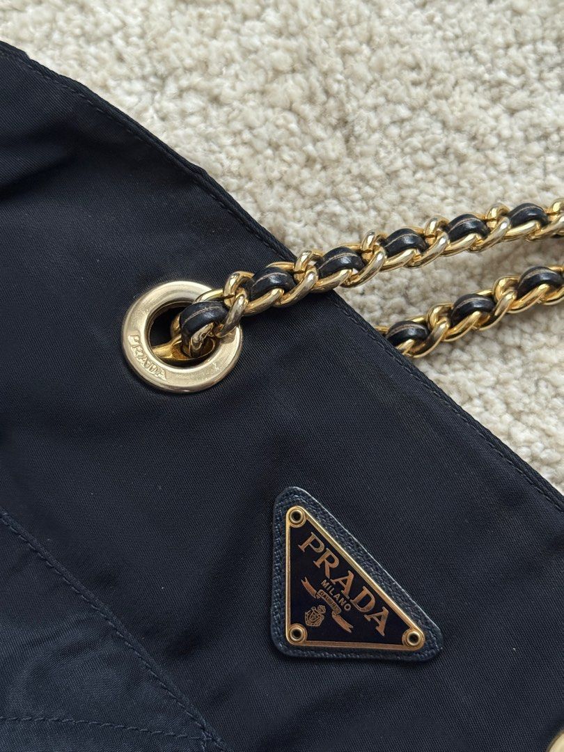 Prada Nylon Chain Bag (Category: Luxury Bags & Wallets) located in Manila. Submitted by jazzzzz06 (Listing ID 1404211776, Image 3). Description: - Authentic Prada Shoulder bag -with authenticity card - Navy Blue (near black) nylon material - Elegant gold-tone chain straps -dust bag included - Stylish quilted design - Secure zipper closure .