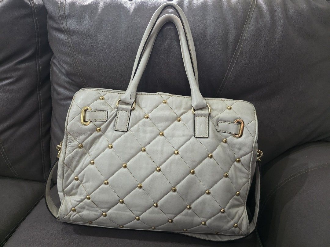 Preloved Michael Kors Hamilton Bag (Category: Luxury Bags & Wallets) located in Paranaque City. Submitted by jillzv (Listing ID 1404229562, Image 2). Description: Preloved Michael Kors Hamilton Bag -With Gold Studs and Hardware -Multi-pocket and zip compartments -As is where is. RFS: Decluttering. Shipping care of buyer. .