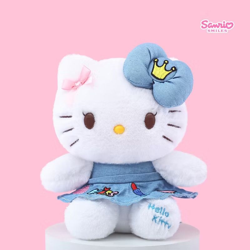 Sanrio Smiles Hello Kitty Plush Toy (Category: Plushies & Soft Toys) located in Manila. Submitted by cici318 (Listing ID 1404363752, Image 1). Description: Adorable Kitty plush toy from Sanrio Smiles. Features a white body, a blue bow with a crown, and a denim dress. The dress has colorful details and the words " Kitty" embroidered on the leg. Perfect for Kitty fans and collectors..