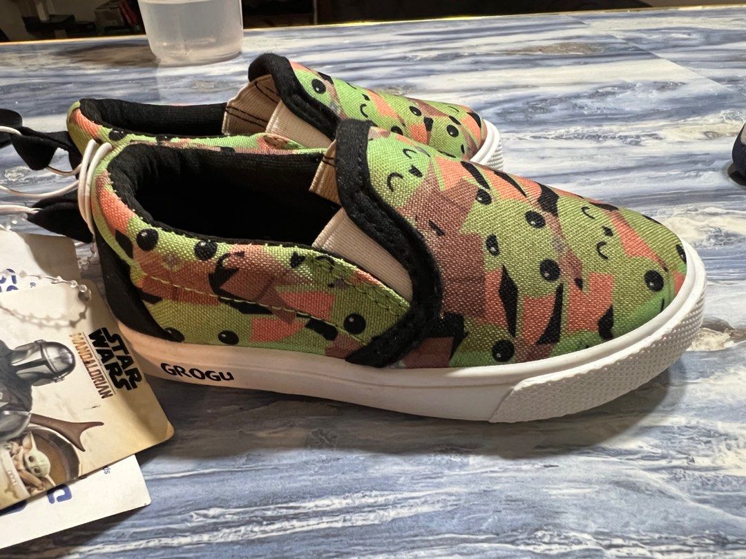 Star Wars Grogu Slip-on Shoes (Category: Babies & Kids Fashion) located in Baliuag. Submitted by sol_marie03 (Listing ID 1404330734, Image 1). Description: - Adorable Grogu slip-on shoes - Features a fun all-over print of Grogu's face - White sole and black trim - Brand: Ross - Perfect for young Star Wars fans! -Size5 -unisex .
