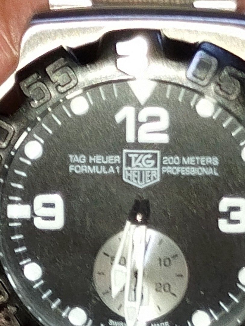 Tag Heuer Formula 1 200M Professional Watch (Category: Men's Watches) located in Quezon City. Submitted by jonathan_ilog18 (Listing ID 1404312994, Image 1). Description: - Tag Heuer Formula 1 watch - Black dial with luminous markers and hands - Stainless steel bracelet - Rotating bezel - Water-resistant to 200 meters - Date display at 3 o'clock - Folding clasp.