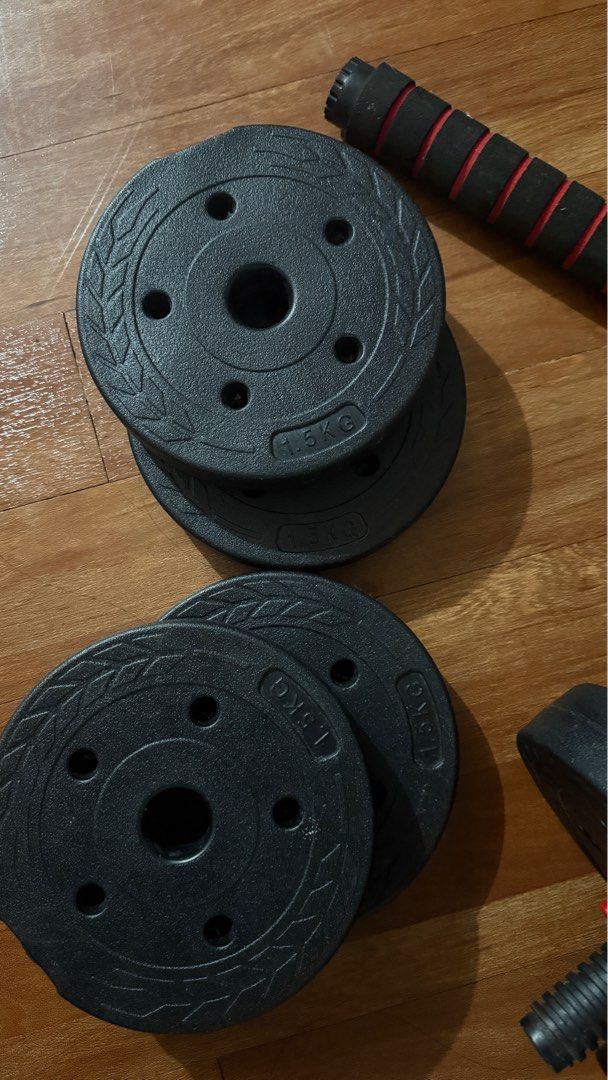 Adjustable Dumbbell Set (Category: Weights & Dumbbells) located in Marikina City. Submitted by jujuthangz (Listing ID 1404538479, Image 2). Description: - Adjustable dumbbell set - Includes two dumbbell handles - Multiple weight plates (1.5KG each) - Red and black grip for comfortable use - Perfect for home strength training.