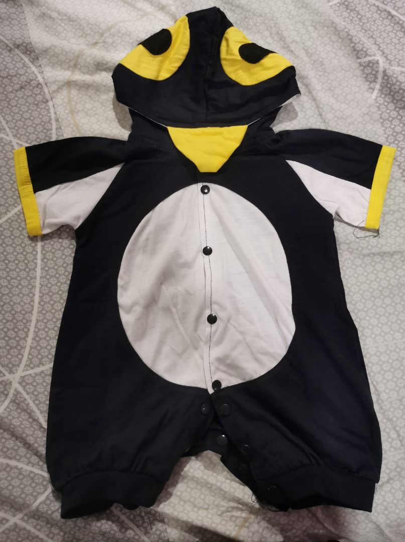 Baby Penguin Onesie (Category: Babies & Kids Fashion) located in Quezon City. Submitted by declutteringmami (Listing ID 1404572774, Image 2). Description: - Adorable penguin onesie for babies. - Features a black and white body. - White belly and black sleeves. - Hood with a yellow beak. - Yellow cuffs on the sleeves. - Convenient snap closures down the front. - used once - 9-12 months.
