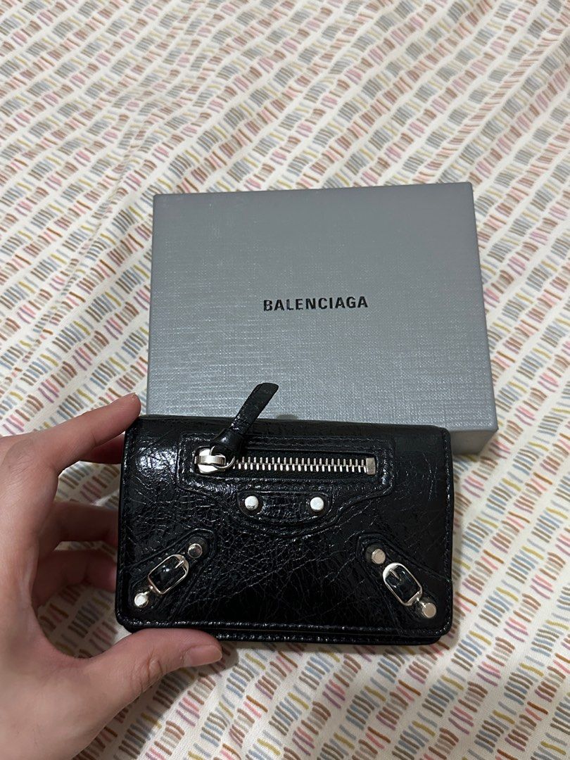 Balenciaga Classic City Wallet (Category: Luxury Bags & Wallets) located in Manila. Submitted by biancamarie03 (Listing ID 1404529985, Image 1). Description: - Balenciaga Classic City wallet - Black color - Zip closure - Snap closure - Multiple card slots - Textured leather finish - Silver-tone hardware - Includes original box.