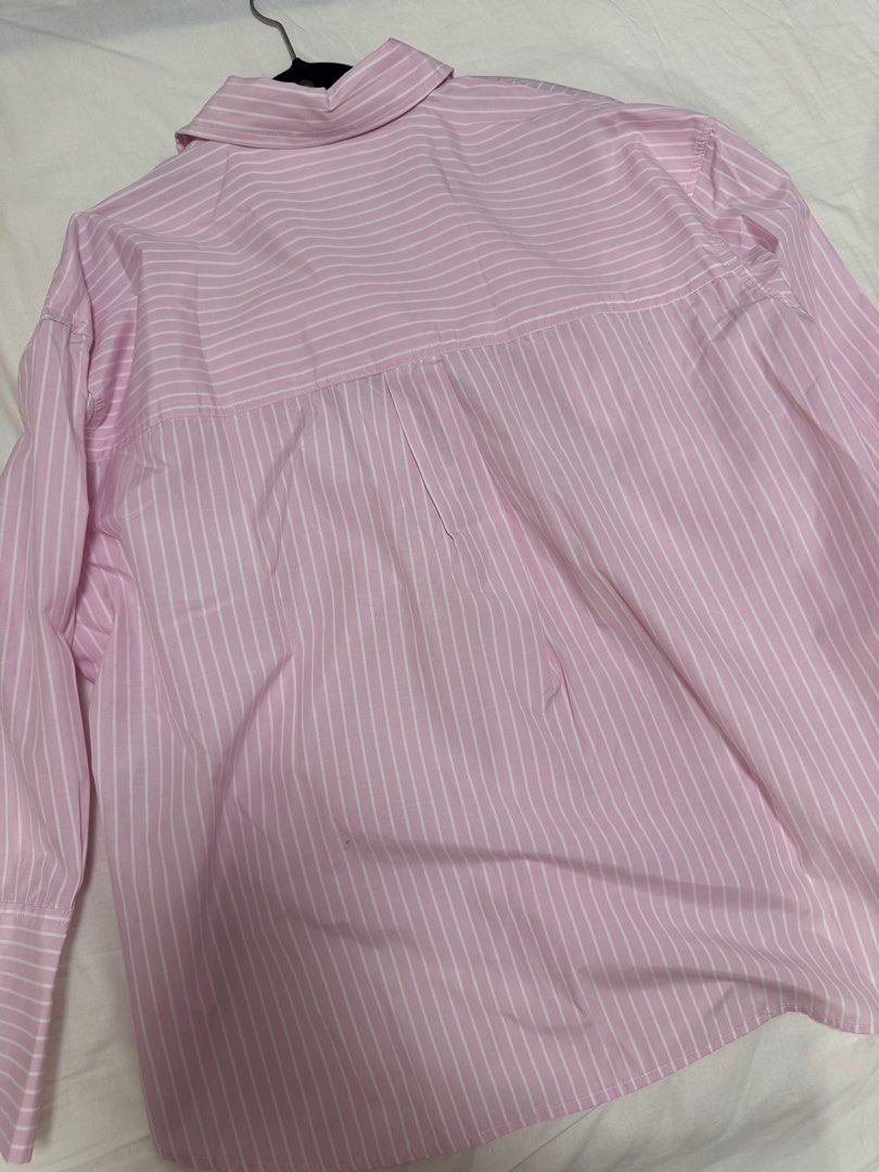Bershka Pink Striped Shirt (Category: Shirts) located in San Juan City. Submitted by baudeclutter (Listing ID 1404567196, Image 2). Description: - Bershka striped shirt - Color: Pink and white - Features: - Collared neckline - Long sleeves - Chest pocket - Button-down closure - Size: EUR XS, US XS, MEX 24 - Made in India.