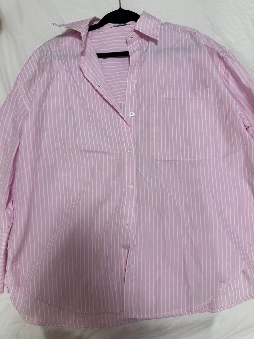 Bershka Pink Striped Shirt (Category: Shirts) located in San Juan City. Submitted by baudeclutter (Listing ID 1404567196, Image 1). Description: - Bershka striped shirt - Color: Pink and white - Features: - Collared neckline - Long sleeves - Chest pocket - Button-down closure - Size: EUR XS, US XS, MEX 24 - Made in India.