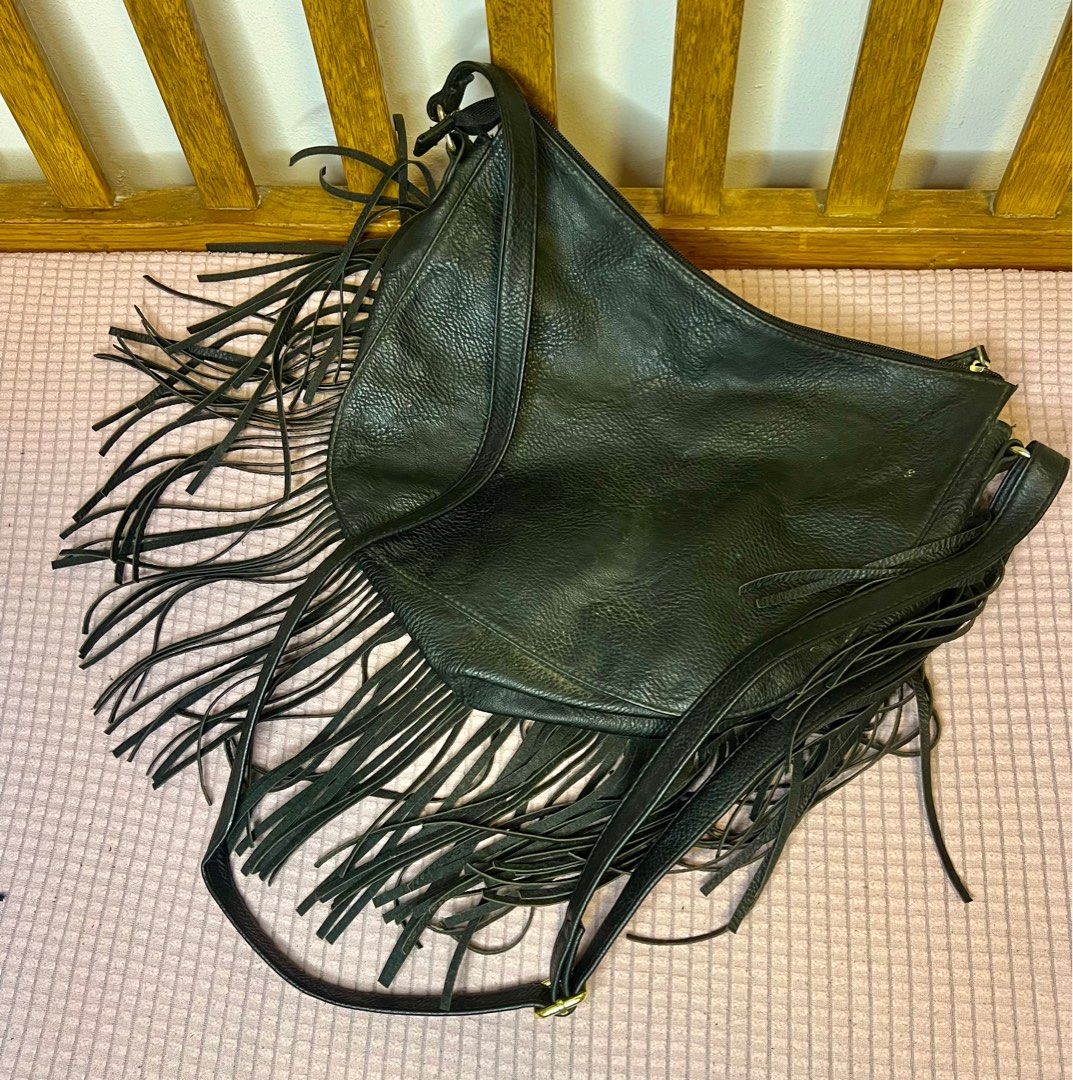 Black Fringe Crossbody Bag (Category: Cross-body Bags) located in Antipolo. Submitted by love_misspetals (Listing ID 1404481787, Image 2). Description: - Black crossbody bag - Features fringe detailing - Adjustable long strap - Gold-colored stud accents - Flap closure - Made of leather-like material - Perfect for a bohemian look.