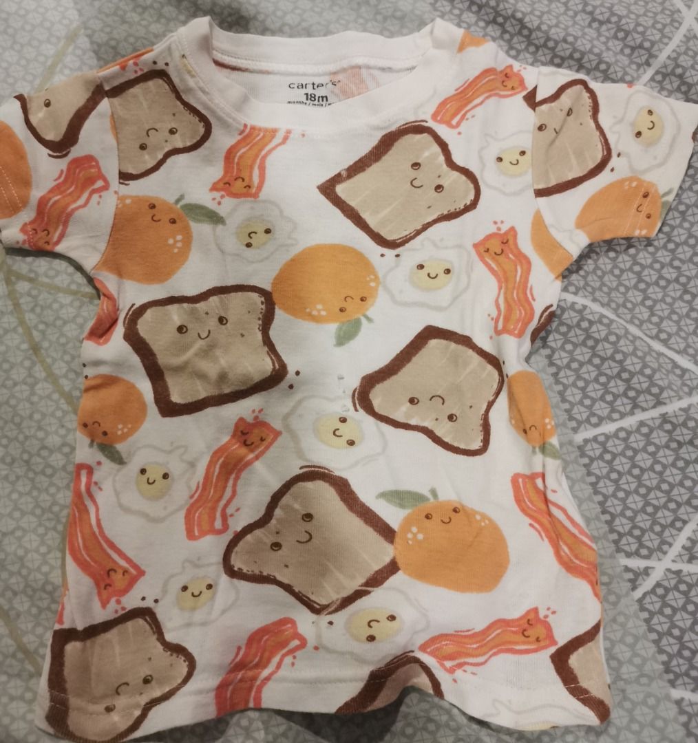 Carter's Breakfast Print Outfit 18M (Category: Babies & Kids Fashion) located in Quezon City. Submitted by declutteringmami (Listing ID 1404571613, Image 2). Description: - Carter's outfit - Size: 18M - Includes: Short-sleeved top and shorts - Print: Breakfast theme (toast, bacon, eggs, oranges) - Color: White - Perfect for your baby! - has 2 small holes in front of the shirt.