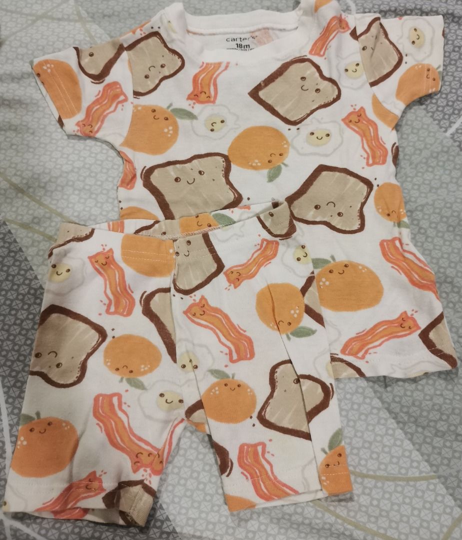 Carter's Breakfast Print Outfit 18M (Category: Babies & Kids Fashion) located in Quezon City. Submitted by declutteringmami (Listing ID 1404571613, Image 1). Description: - Carter's outfit - Size: 18M - Includes: Short-sleeved top and shorts - Print: Breakfast theme (toast, bacon, eggs, oranges) - Color: White - Perfect for your baby! - has 2 small holes in front of the shirt.