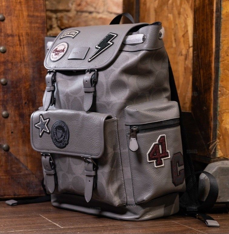 Coach Patchwork Backpack - Grey (Category: Backpacks) located in Singapore. Submitted by joyladder21 (Listing ID 1404381871, Image 2). Description: Stylish Coach backpack in grey with patchwork details. Features multiple compartments and adjustable straps. Perfect for everyday use or travel. Excellent condition, as shown in the photos. Purchased from a Coach outlet. used once like brandnew..