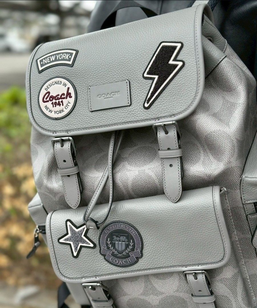 Coach Patchwork Backpack - Grey (Category: Backpacks) located in Singapore. Submitted by joyladder21 (Listing ID 1404381871, Image 3). Description: Stylish Coach backpack in grey with patchwork details. Features multiple compartments and adjustable straps. Perfect for everyday use or travel. Excellent condition, as shown in the photos. Purchased from a Coach outlet. used once like brandnew..