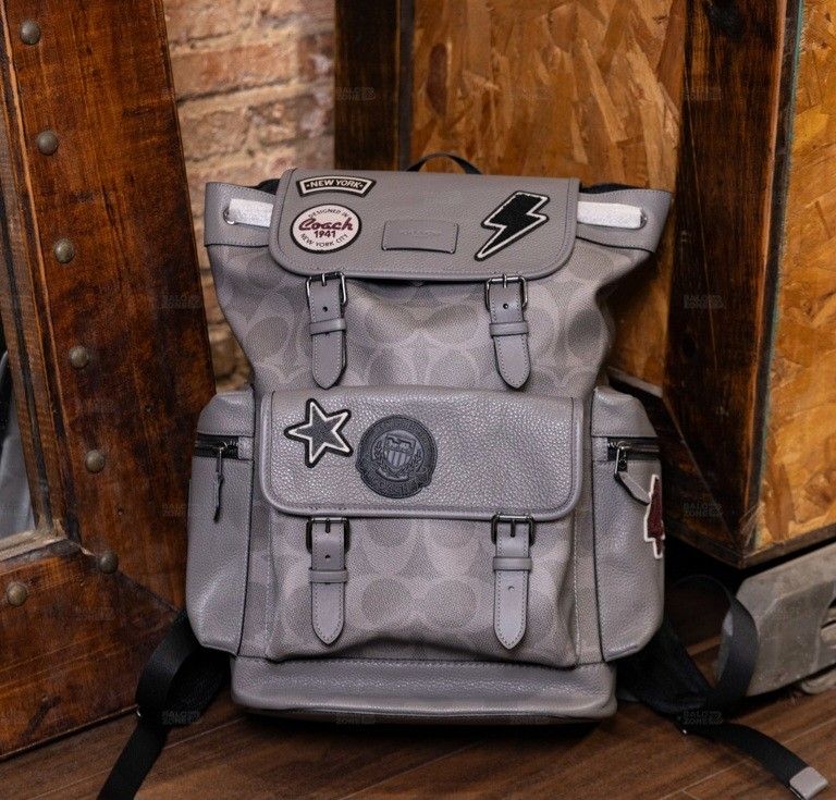 Coach Patchwork Backpack - Grey (Category: Backpacks) located in Singapore. Submitted by joyladder21 (Listing ID 1404381871, Image 1). Description: Stylish Coach backpack in grey with patchwork details. Features multiple compartments and adjustable straps. Perfect for everyday use or travel. Excellent condition, as shown in the photos. Purchased from a Coach outlet. used once like brandnew..