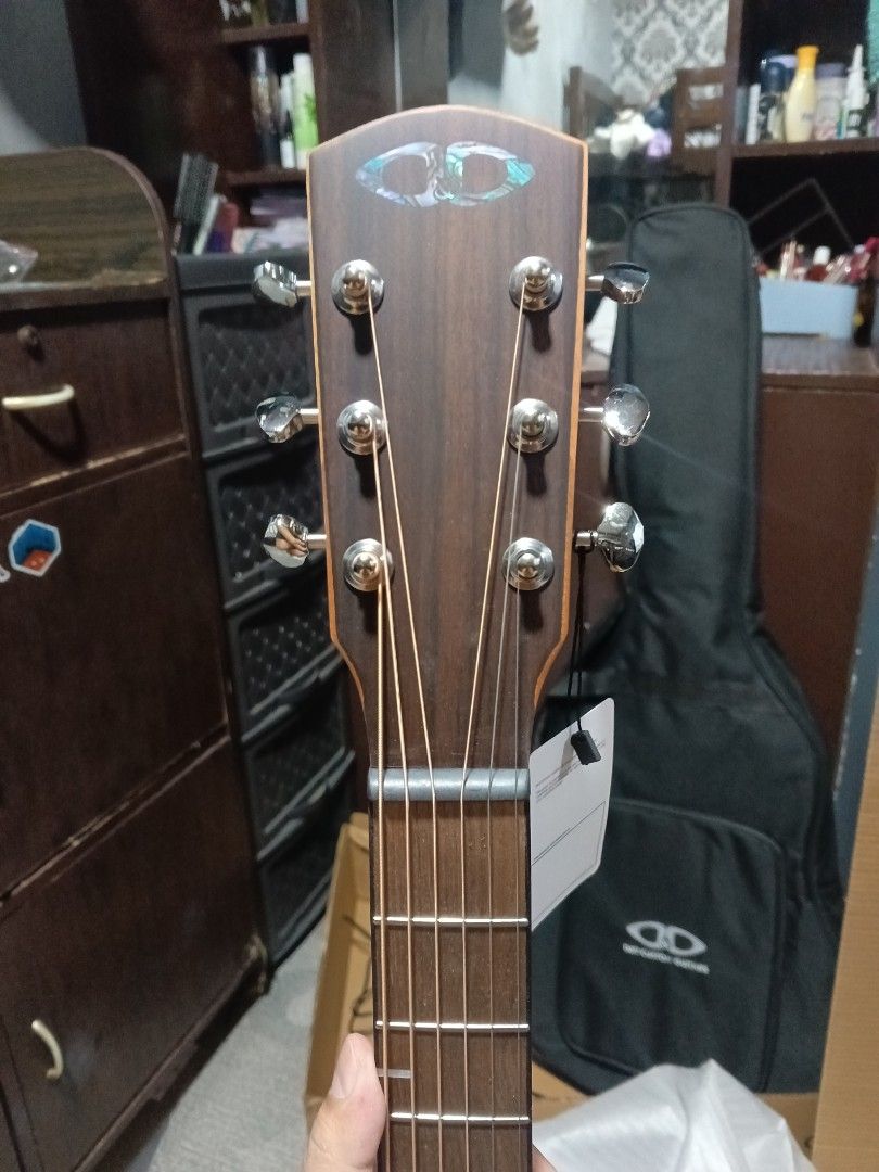 D&D Custom Guitars Acoustic Guitar Django Sr. (Category: Musical Instruments) located in Caloocan City. Submitted by royalfish_02affa (Listing ID 1404458097, Image 2). Description: D&D Custom Guitars acoustic guitar is a beautiful instrument. It features a natural wood finish and a cutaway design. The guitar comes with a case and is in its original packaging. The headstock has the D&D logo. The guitar has six strings and a rosewood fretboard. The