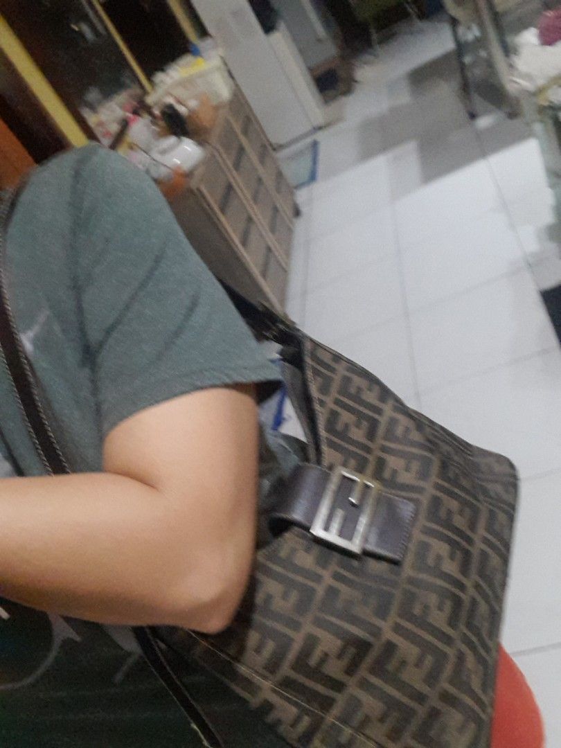 Fendi Hobo Soho Bag (Category: Luxury Bags & Wallets) located in Valenzuela. Submitted by muralungs101 (Listing ID 1404417081, Image 3). Description: NO CODE gold under zip only not ykk zip material: fabric nylon canvas Fendi shoulder bag with the iconic FF logo print. Features a brown leather strap and buckle and full zipper closure. The interior has three compartments. Made in Italy. issue: faded hardwares issue : there is a flaw on the back si